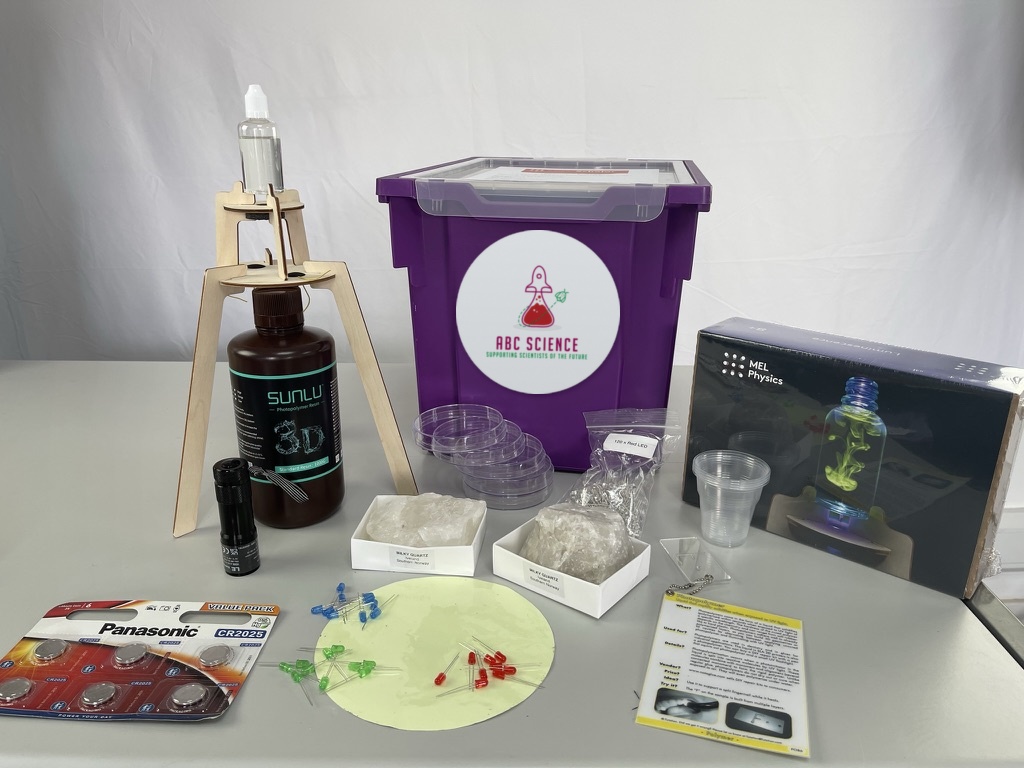 An ABC Science lesson kit with the branded kit box, photopolymer resin, rock samples, LEDs and classroom equipment